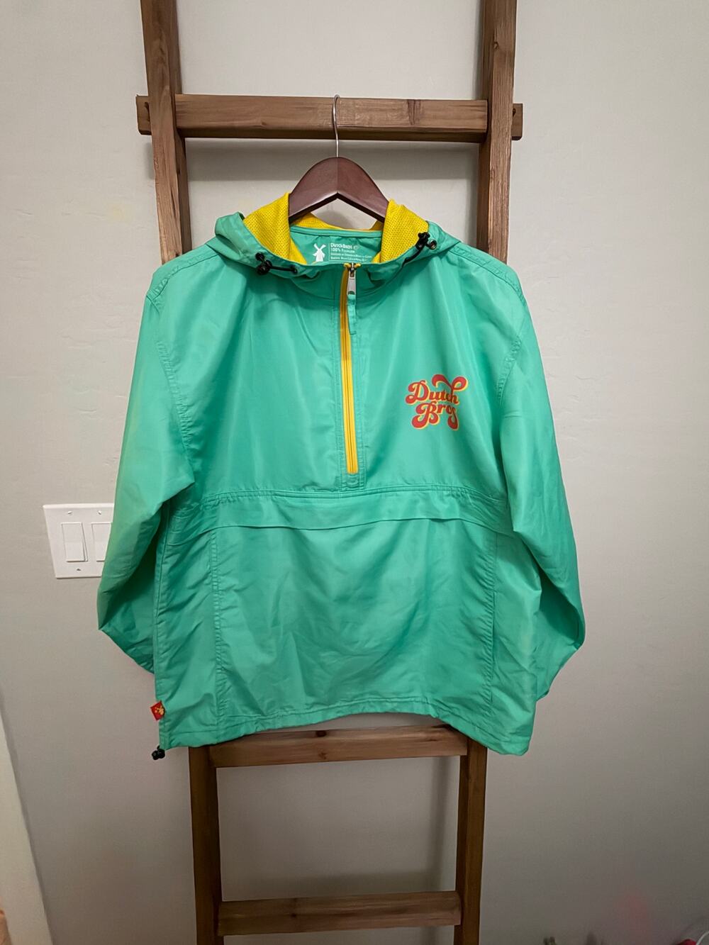 Dutch Bros teal and yellow 1/2 zip hooded windbreaker pullover jacket. - small